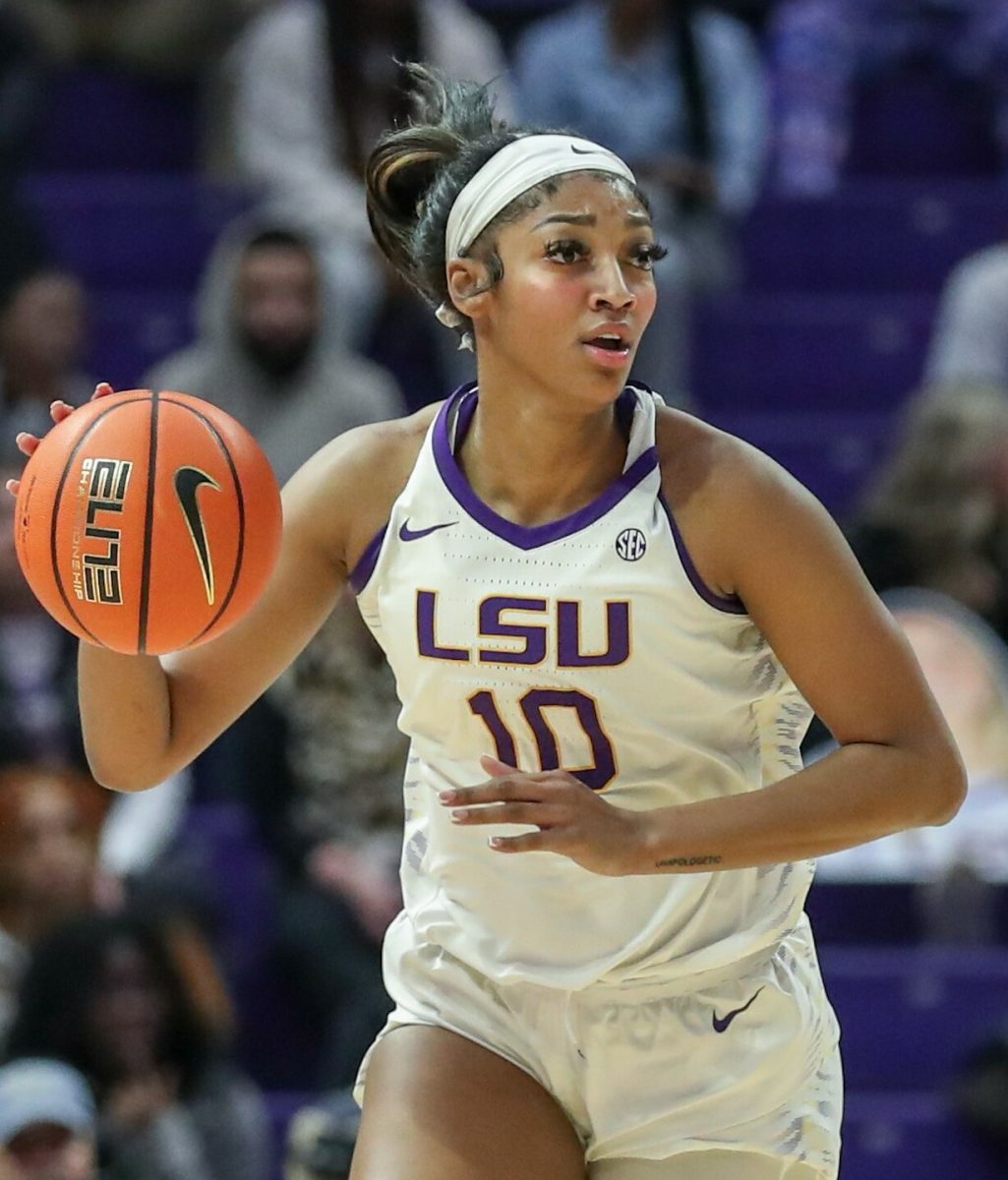 Angel Reese, drafted in the first round of the 2024 WNBA draft by the Chicago Sky, in a collegiate game for LSU. Reese is one of the biggest names in the sport and deserves a larger contract, much like Clark and Cardoso.