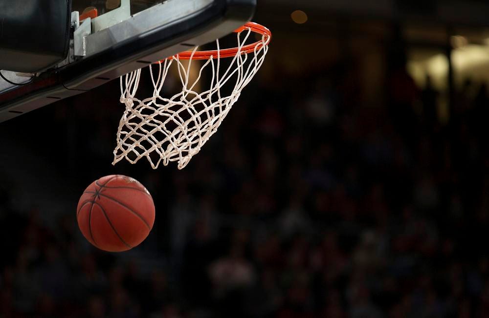 WNBA ball splashing through the hoop