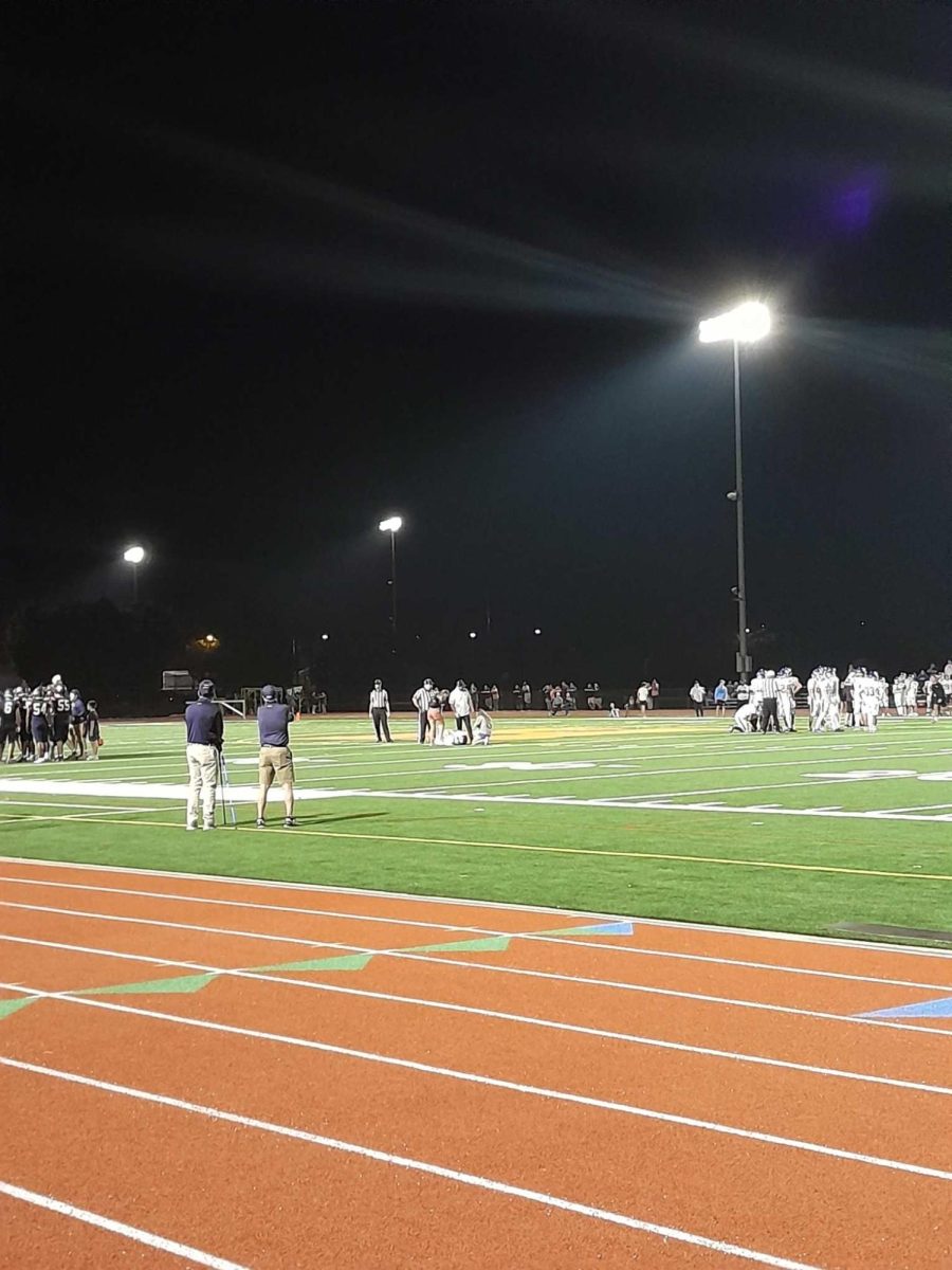 Injured senior Henry Lewis takes a moment on the field.