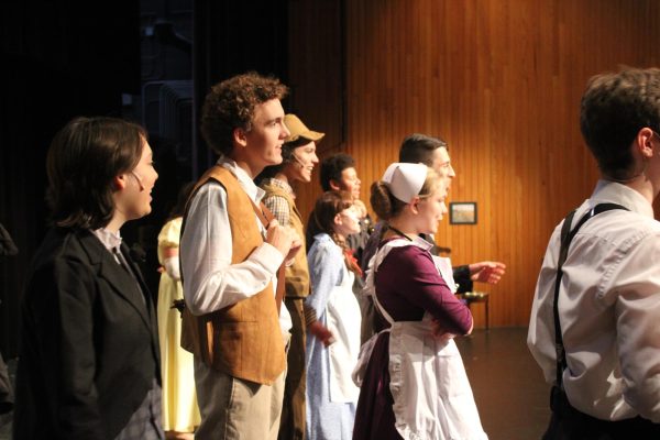 Actors warming up onstage before a show.