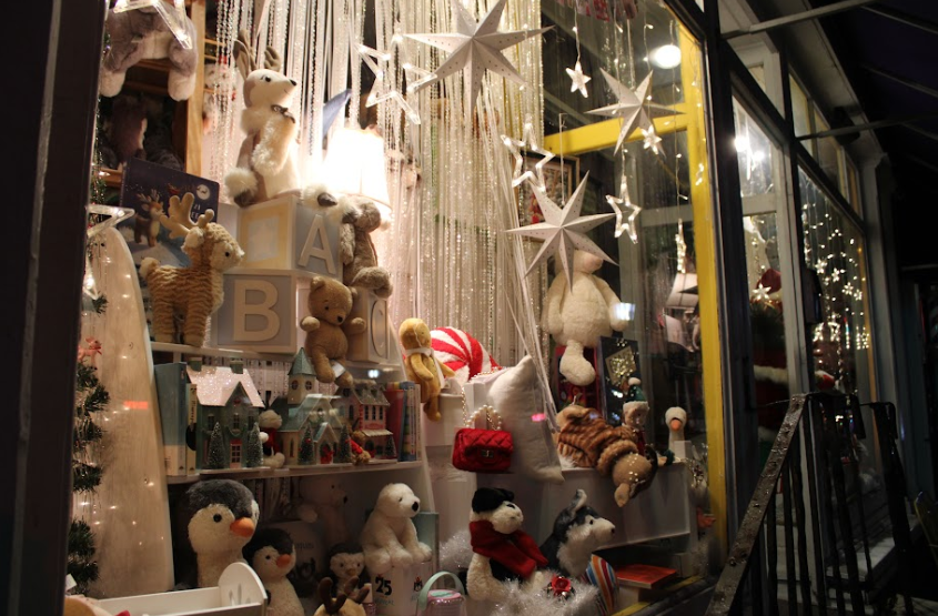 This toy shop is all set for the holiday season, proudly displaying gifts it has to offer, attracting neighborhood kids to the warm glow illuminating the toys in its windows.